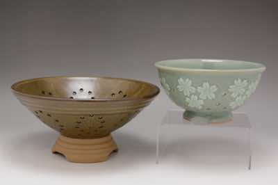 These berry bowls were hand-thrown and hand-carved with patterns such as cherry blossoms.  Holes are carefully arranged and drilled by hand.