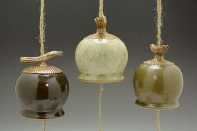These wind chimes were hand-thrown on a pottery wheel and the branch on top was carefully hand-carved to look like a real branch.  They come in tenmoku (dark brown), pun'chong (off-white) with brush-on white-colored slip, olive (dark green), celadon (light green - not shown) and blush (not shown).  Each wind chime is already assembled with natural jute string (and along with it, fishing line to add strength), ceramic striker (to make sound) and wooden windcatcher (on which wishes and blessings can be written with Sharpie pen).  They can be hung outdoor on a porch or under an overhang.